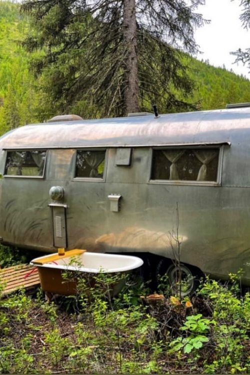An outdoor tub and Airstream trailer at Northwest Montana Retreat, a Montana glamping property