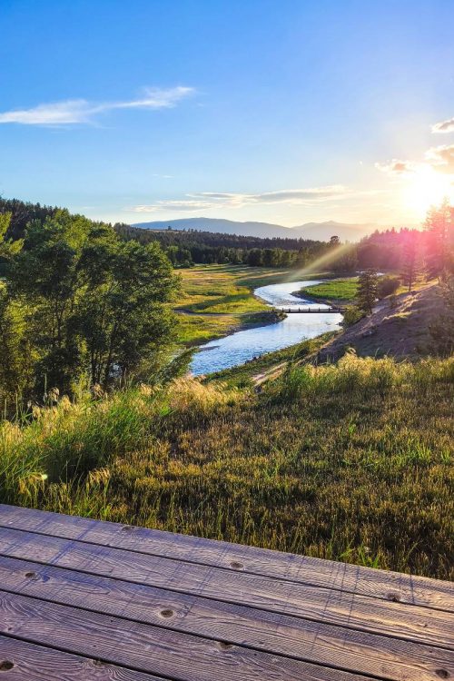 The sun setting over the Tobacco River at a Montana glamping resort